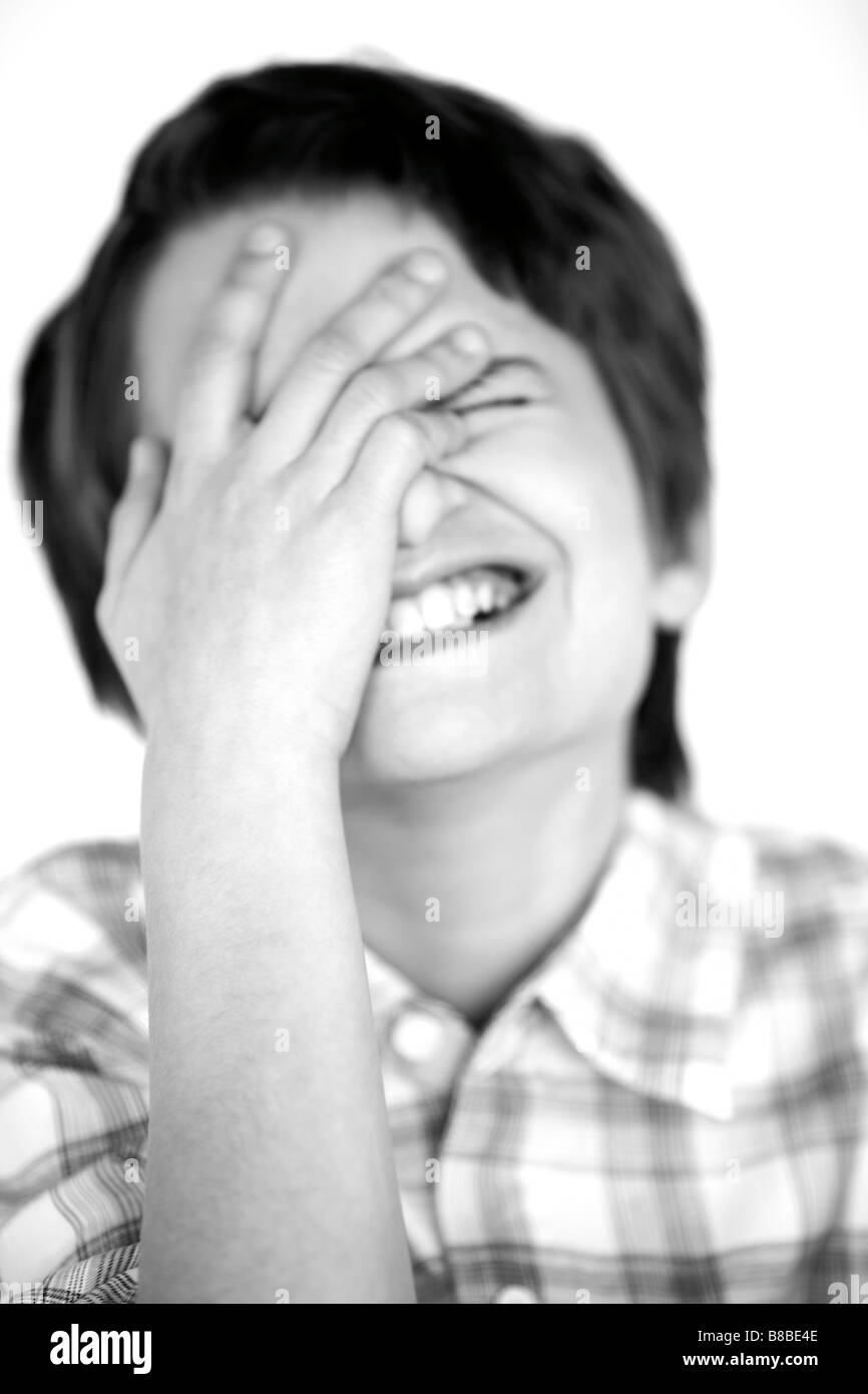 Portrait  Boy Wearing Plaid Shirt Laughing his Hand over his Face Stock Photo