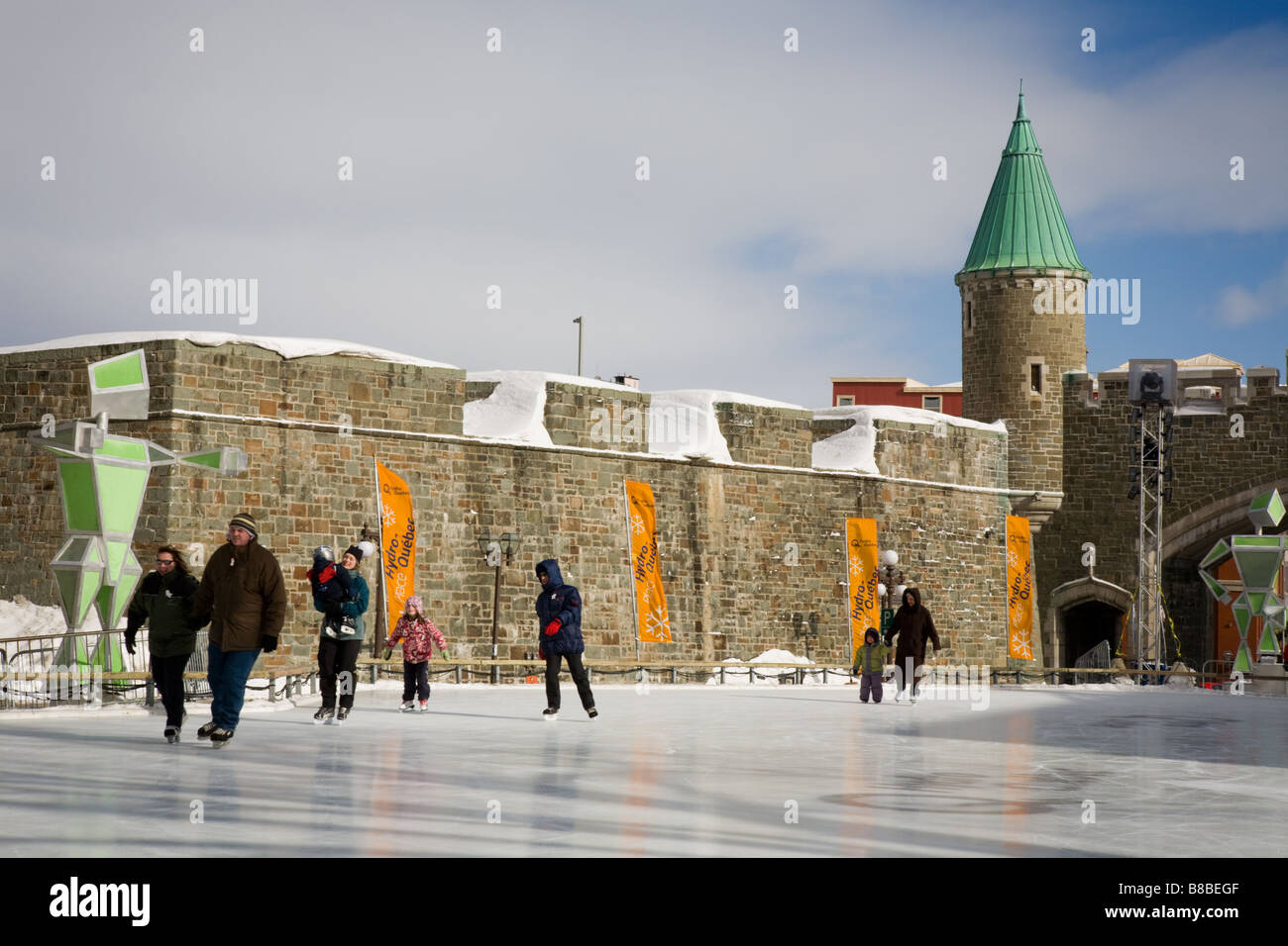 People skating near Porte Saint Jean Place Hydro Quebec Winter Carnival Quebec Canada Stock Photo