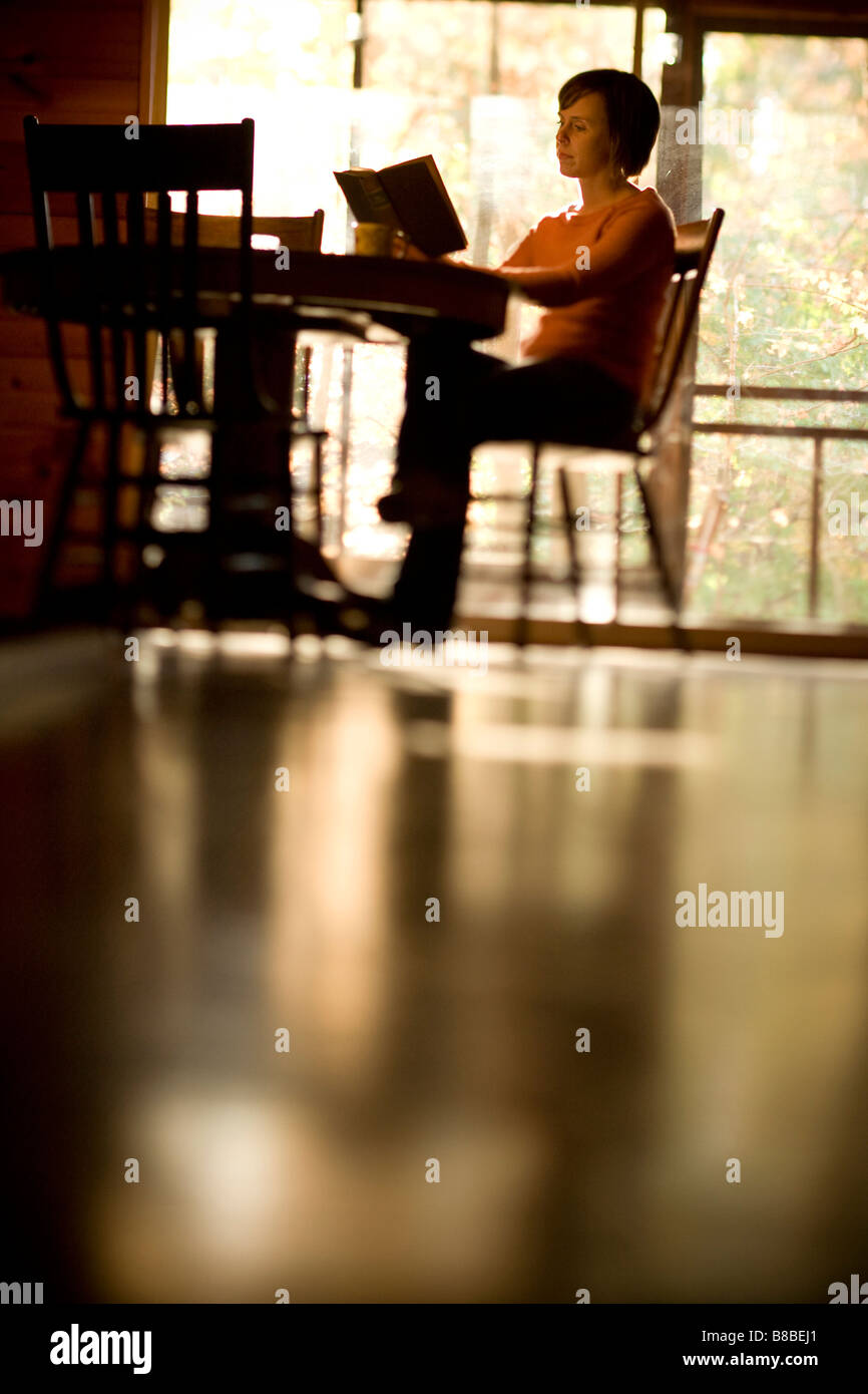 Woman reading a book and relaxing inside a cabin Stock Photo - Alamy