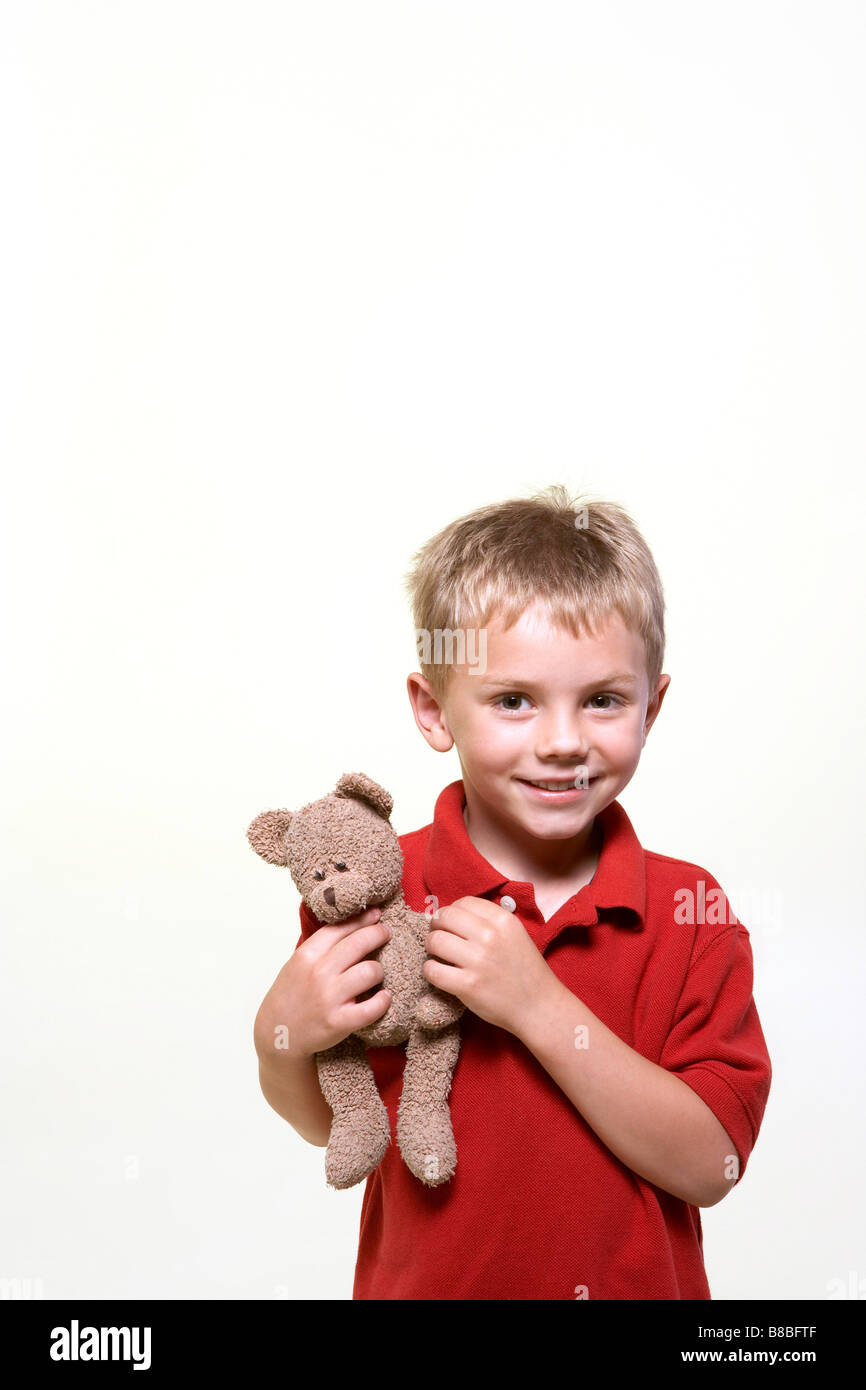 Little Boy Smiling Holding Teddy Bear Stock Photo - Alamy