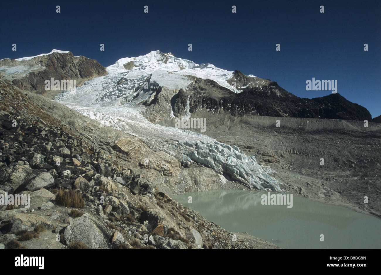 Mt Huayna Potosi and glacial lake, Cordillera Real, Bolivia. Lateral moraine shows where glacier used to be. Stock Photo