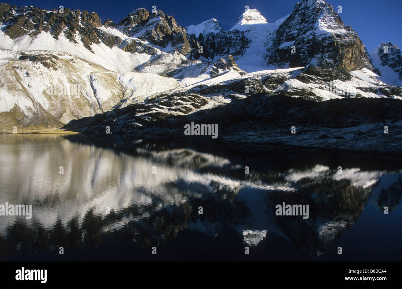 Mt Condoriri reflected in Lake Chiar Kota after a winter snowfall, Cordillera Real, Bolivia Stock Photo