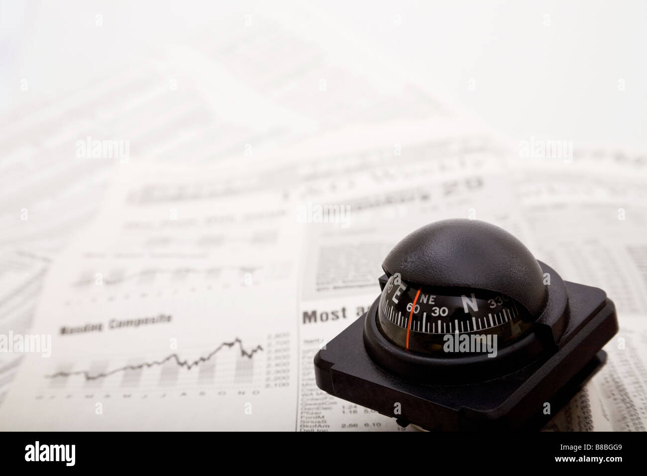 A compass on the financial page of a newspaper Stock Photo