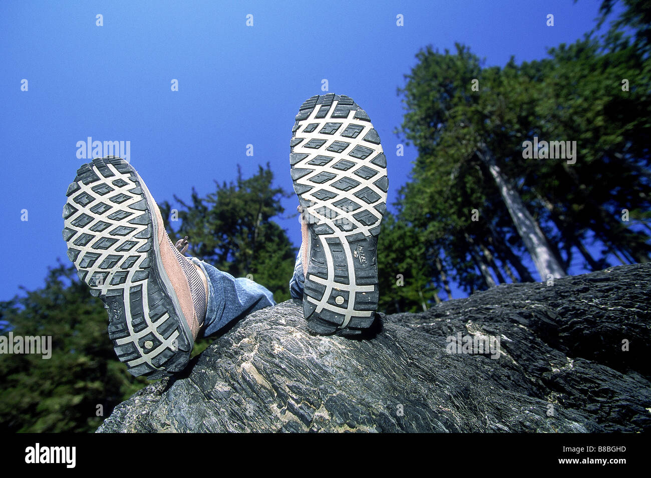 FV5476, Ron Watts; Hiker's legs  boots resting Rocks Stock Photo