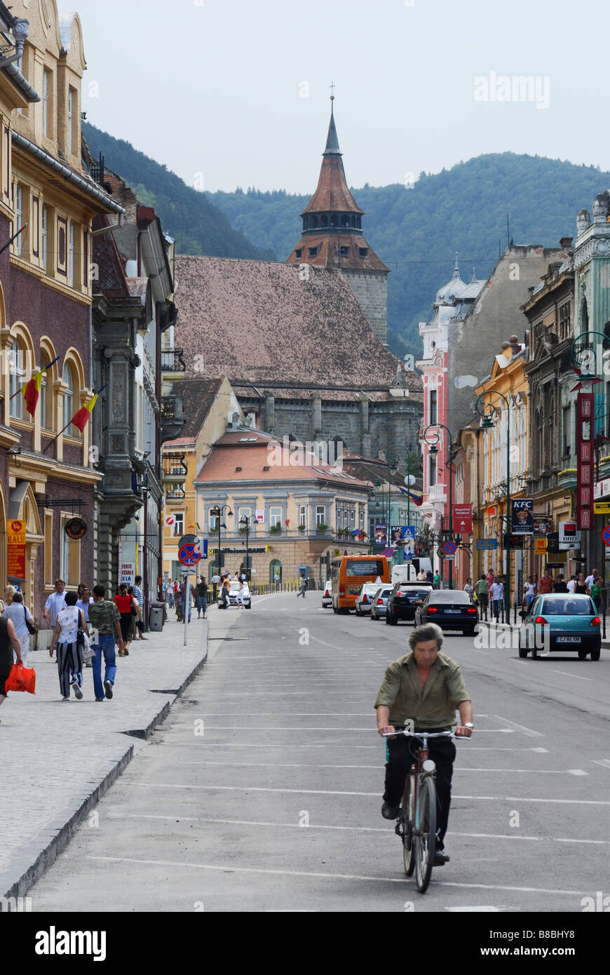 Cyclist cycling down the main street in Brasov Transylvania Romania Stock Photo