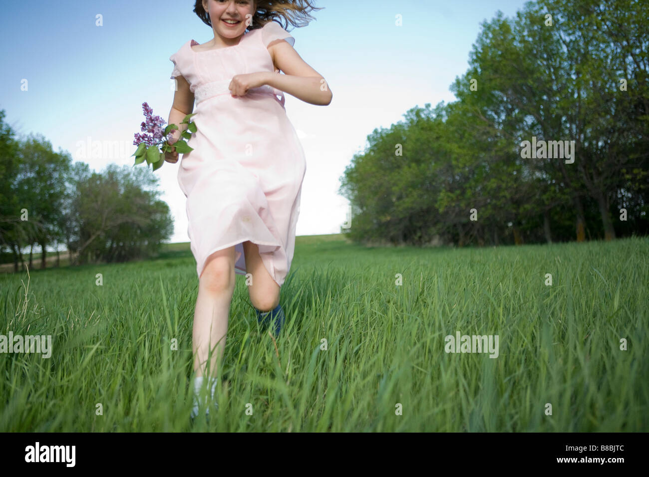 Young Girl Running through Field Flowers Stock Photo Alamy