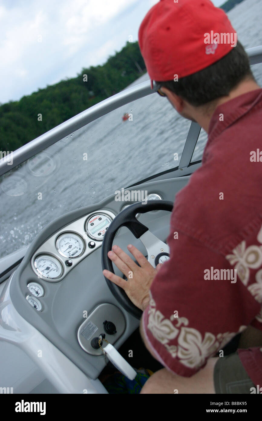 Man driving boat hat hi-res stock photography and images - Alamy