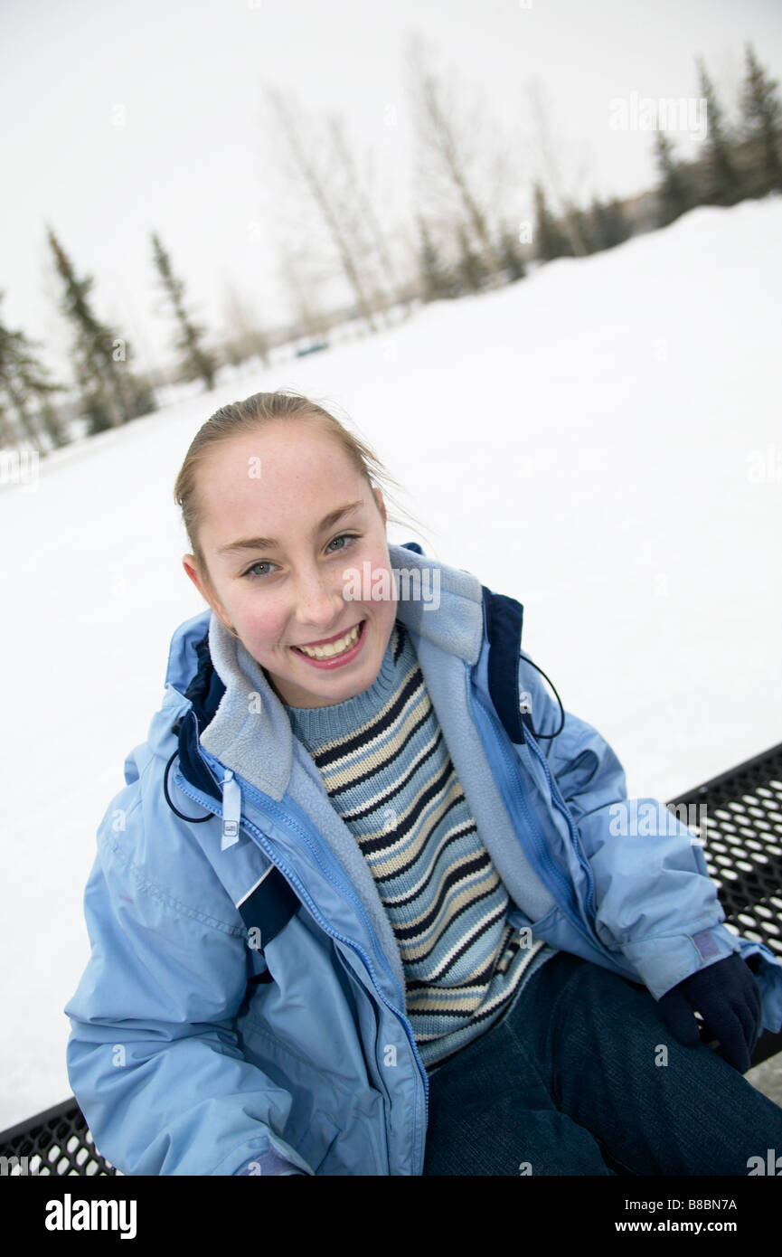 Girl sitting bench Outdoor Ice Rink Stock Photo - Alamy