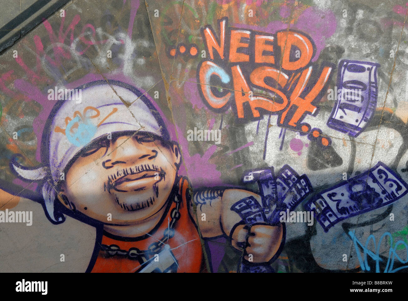 Need Cash: Graffiti of young man throwing around money, Royal Festival Hall skateboard park, South Bank, London Stock Photo