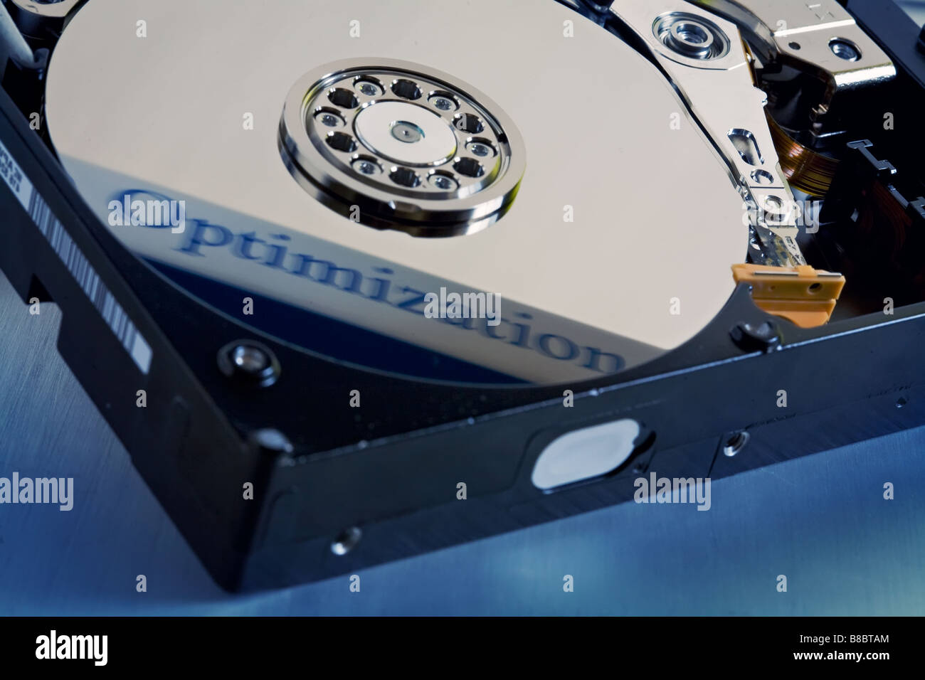 a opened computer hard disk drive with reflected optimization words on