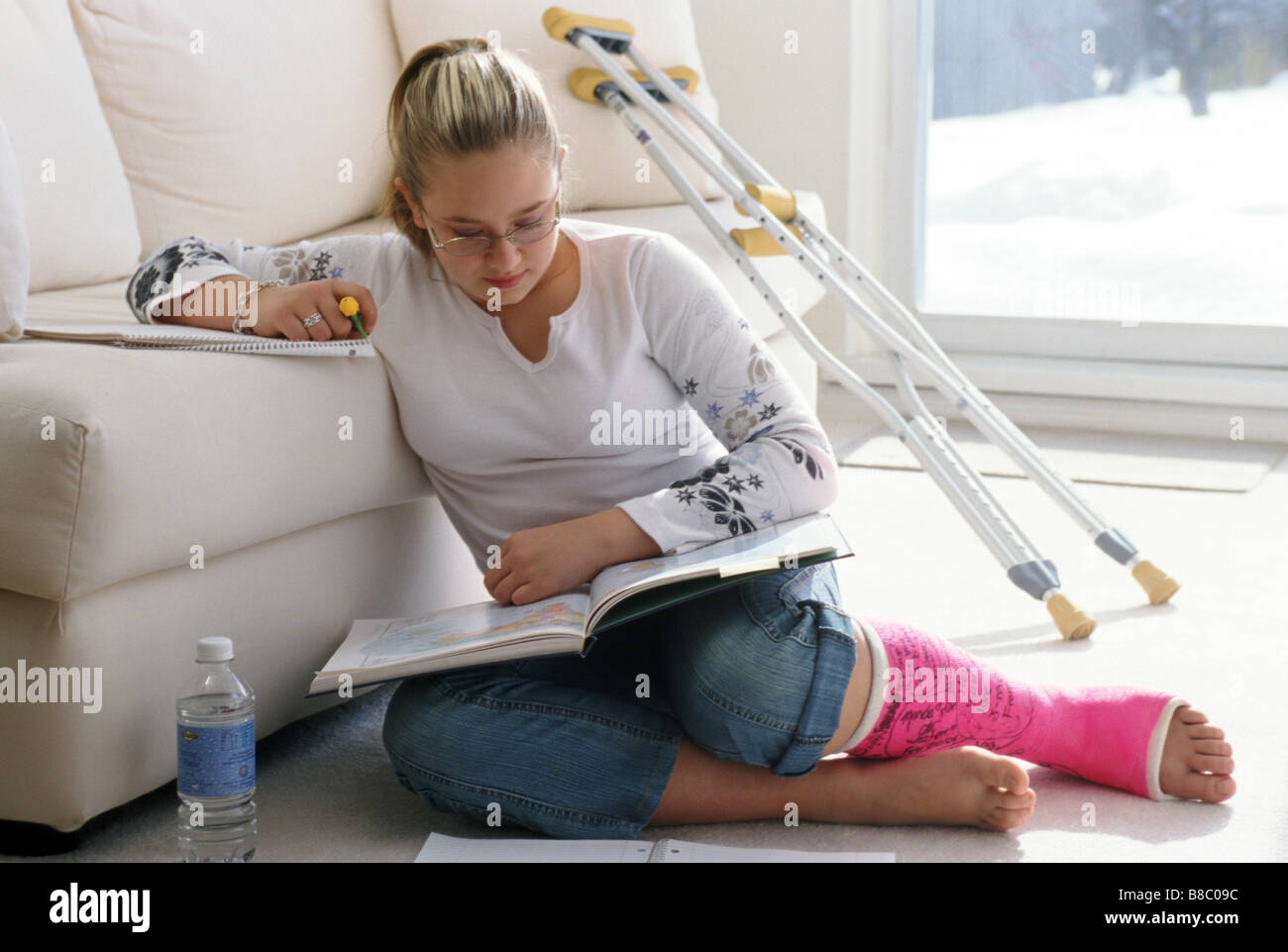 Girl Broken Leg doing Homework Stock Photo Alamy