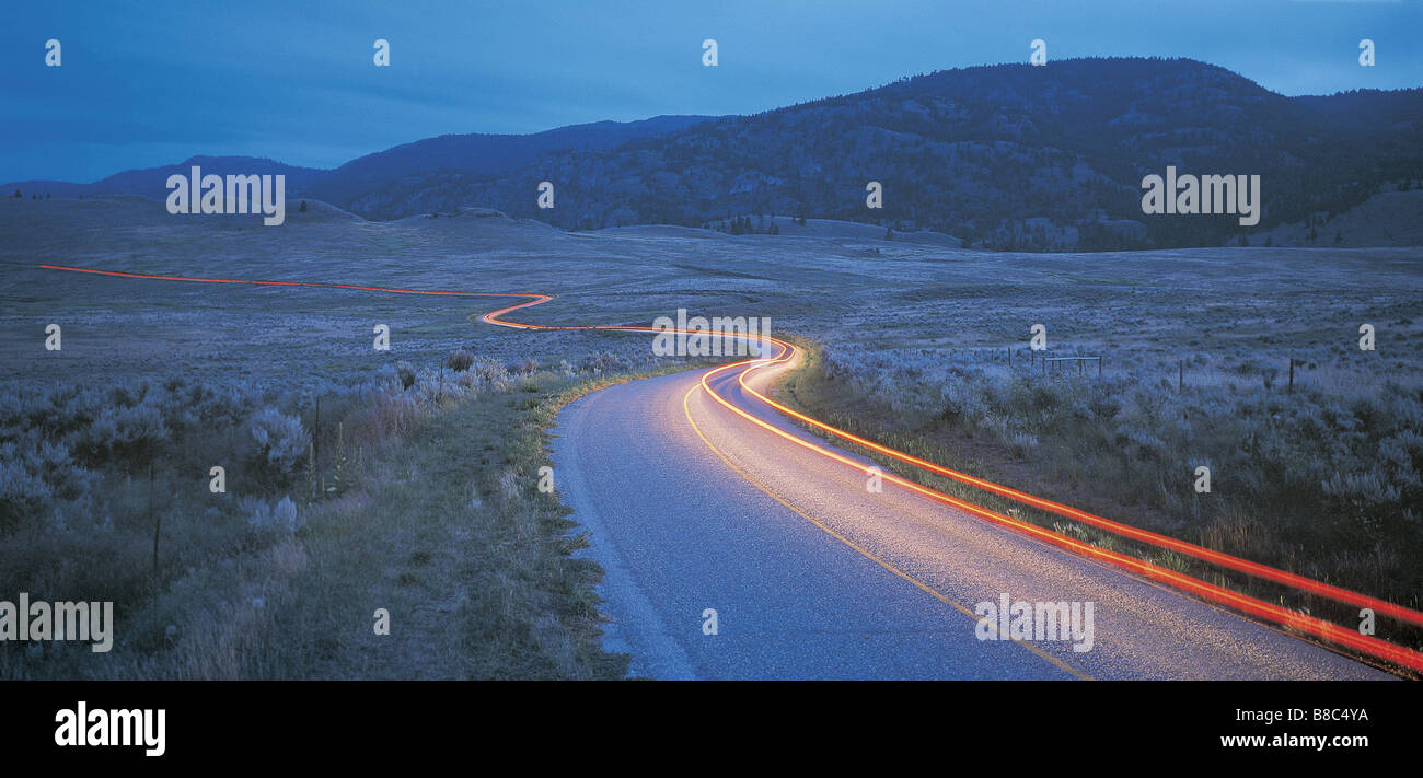 FL5530, David Nunuk; Tail Lights Winding Through Okanagan Valley, BC  Dusk Stock Photo