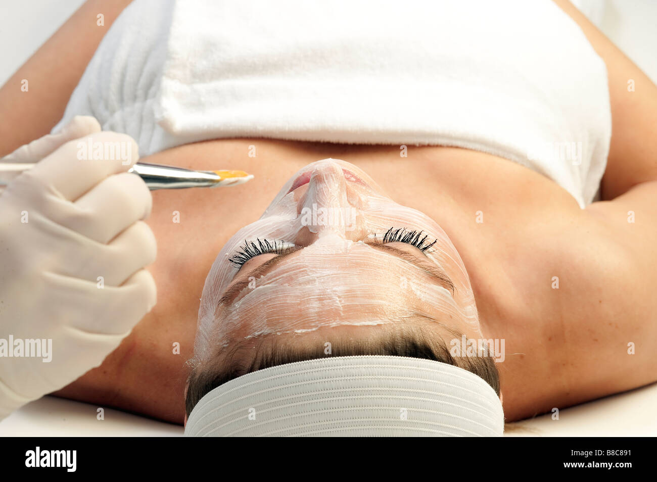 Woman getting a facial treatment at a spa Stock Photo