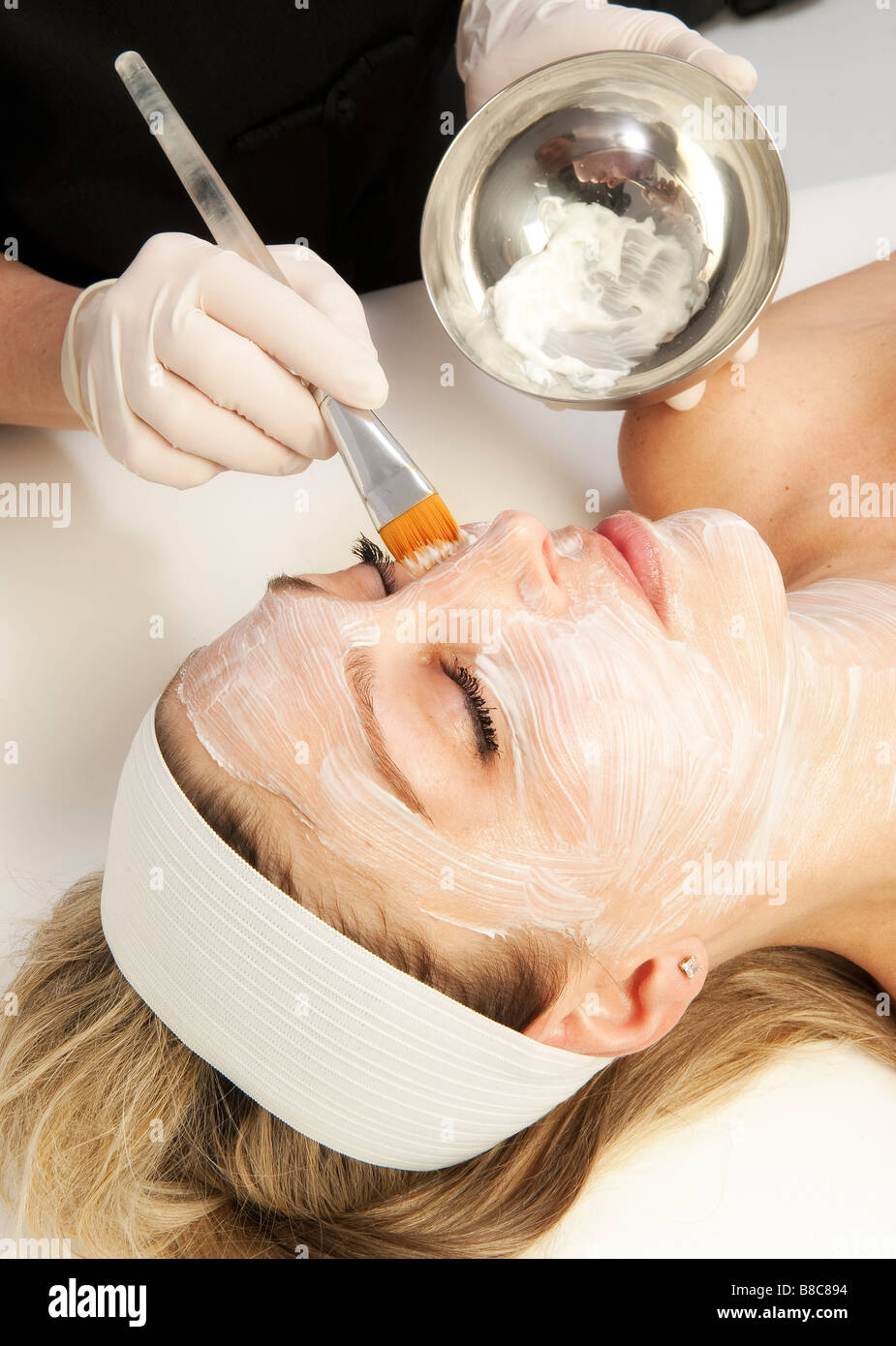 Woman getting a facial treatment at a spa Stock Photo