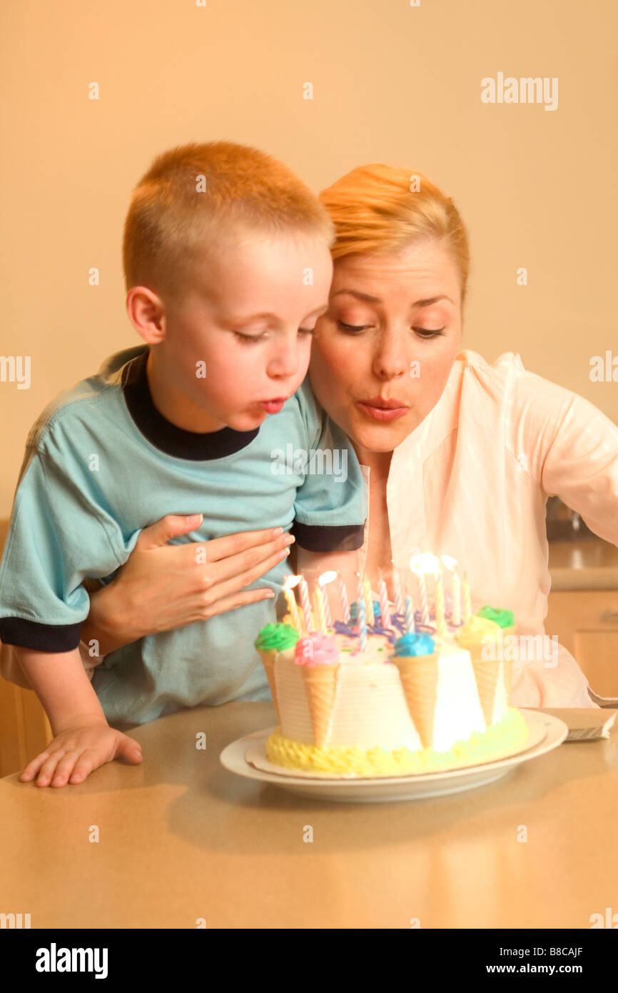 Mother Son blowing out Birthday Candles Stock Photo Alamy