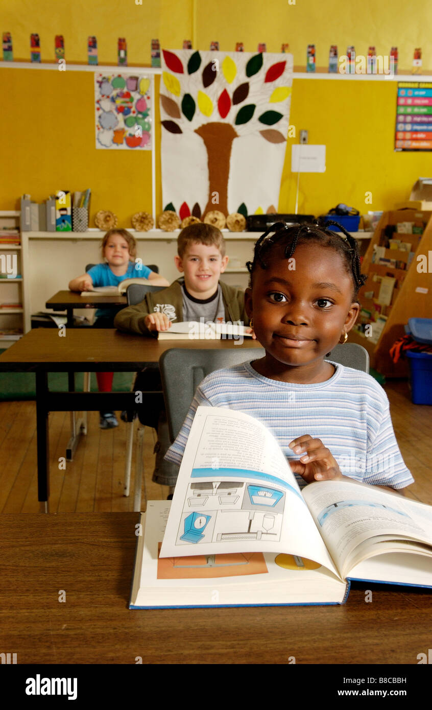 Five Year Old Girl Reading her Desk Classroom Stock Photo Alamy