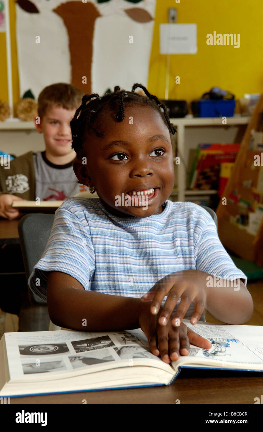 Five Year Old Girl Reading her Desk Classroom Stock Photo Alamy
