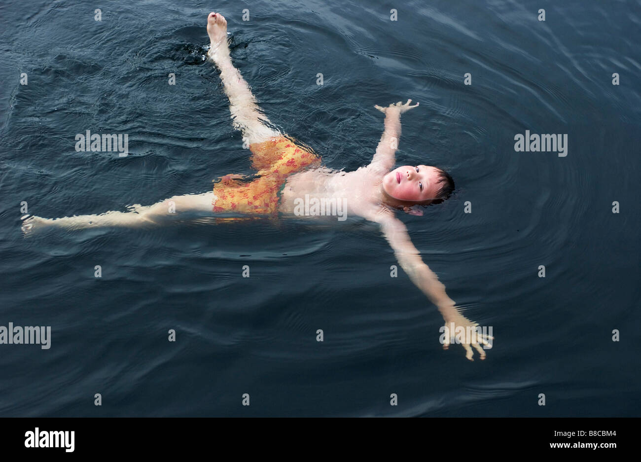 Boy Floating Lac de Neige, Quebec Stock Photo