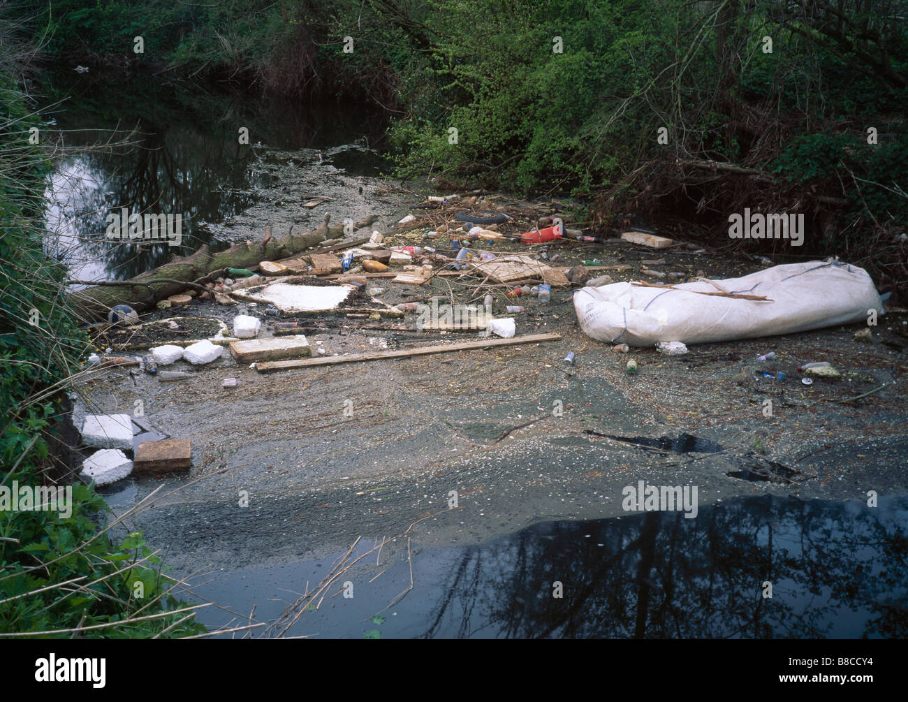 RUBBISH in stream Stock Photo - Alamy