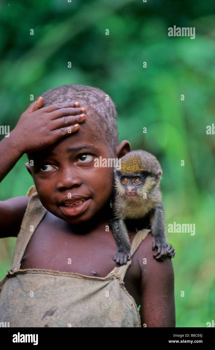 Villager with pet cercopitec monkey Stock Photo