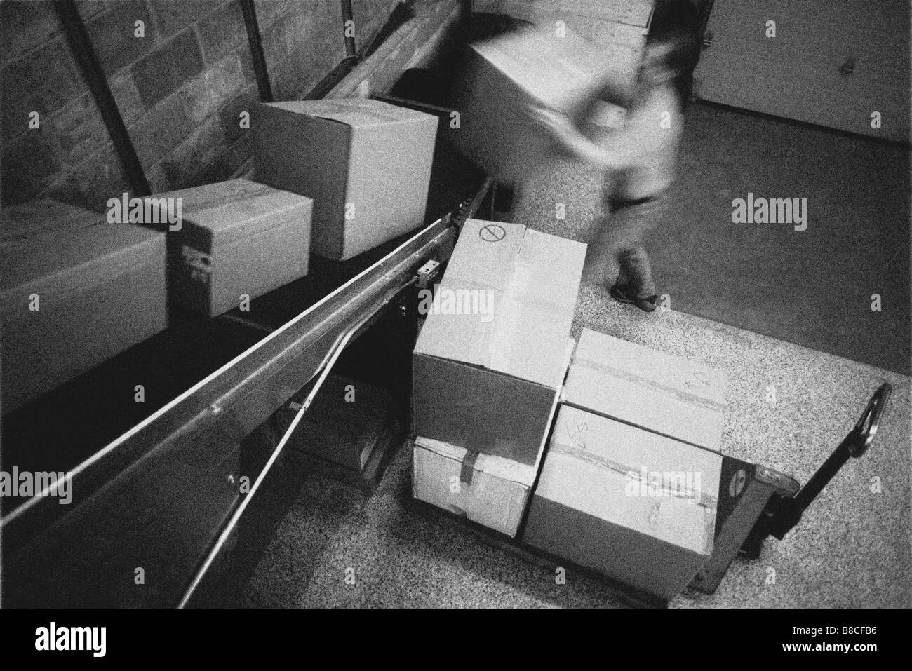 FL6279, Harry Nowell; Man Unloading Boxes Warehouse Stock Photo