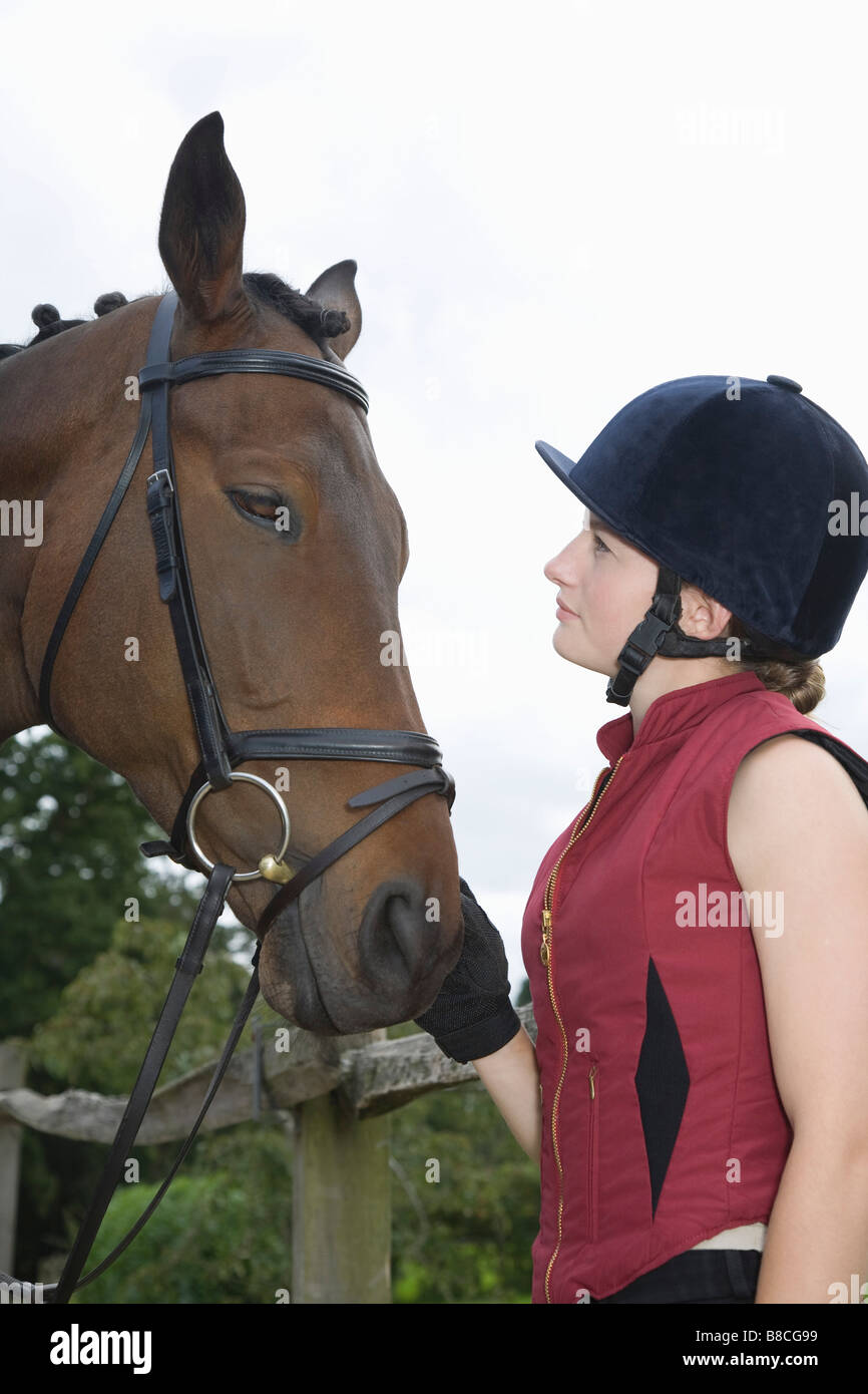 riding hat holding horse Stock Photo 