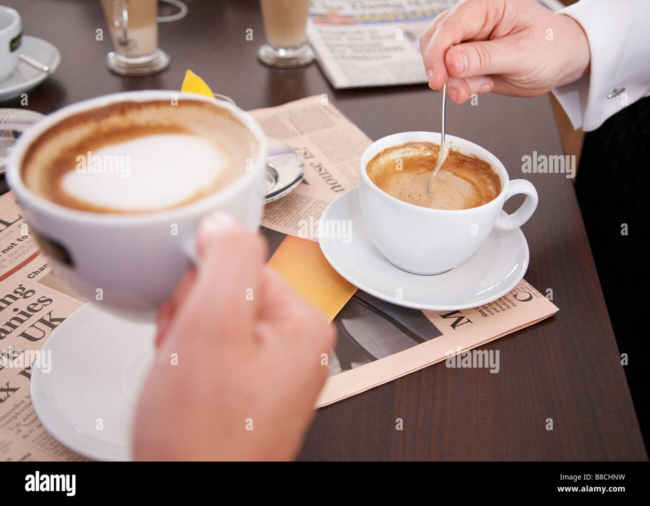 Two people sat drinking coffee Stock Photo Alamy