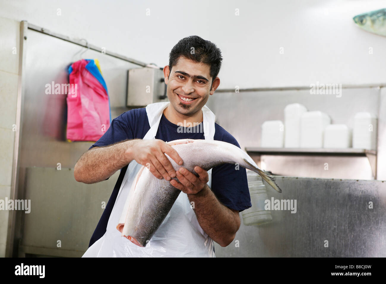 Butcher with Fresh Fish Stock Photo