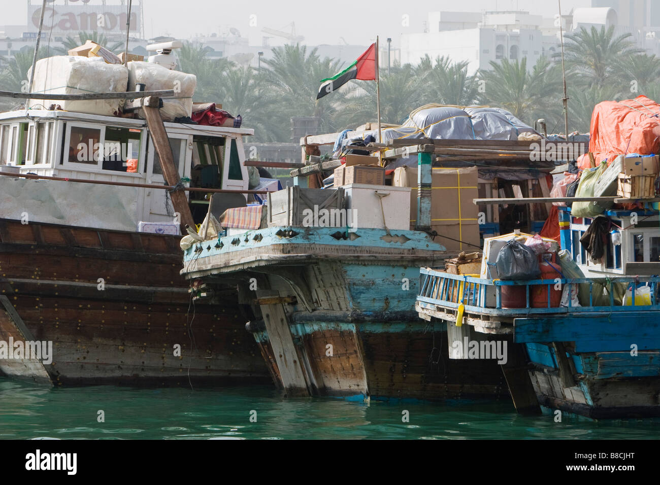 Dubai, UAE, Dhows, old wooden sailing vessels, are docked along the Deira side of Dubai Creek. Stock Photo