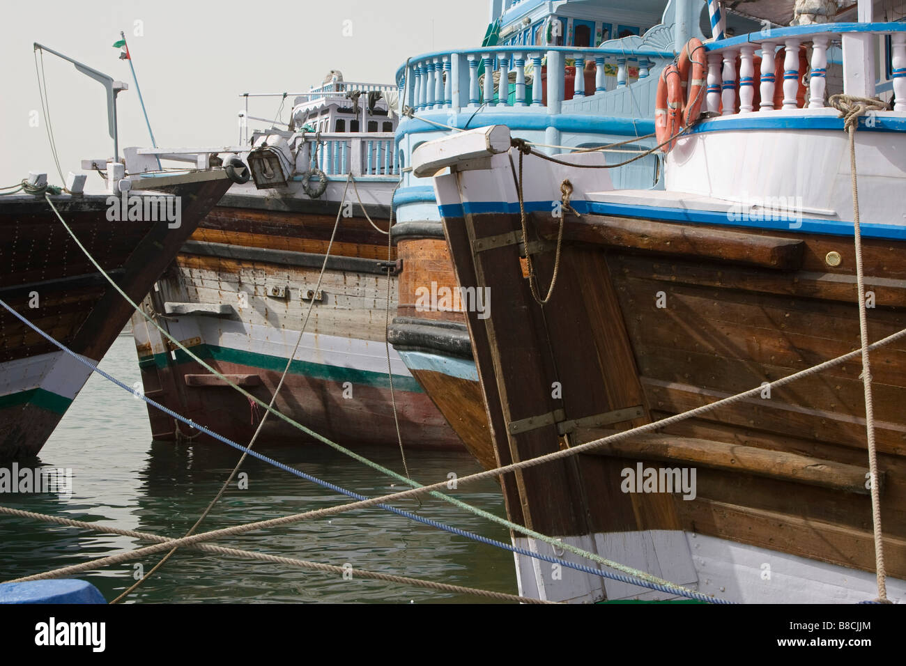 Dubai, UAE, Dhows, old wooden sailing vessels, are docked along the Deira side of Dubai Creek. Stock Photo