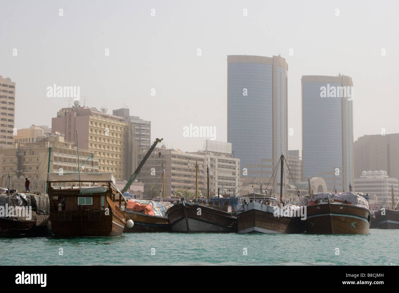 Dubai, UAE, Dhows, old wooden sailing vessels, are docked along the Deira side of Dubai Creek. Stock Photo