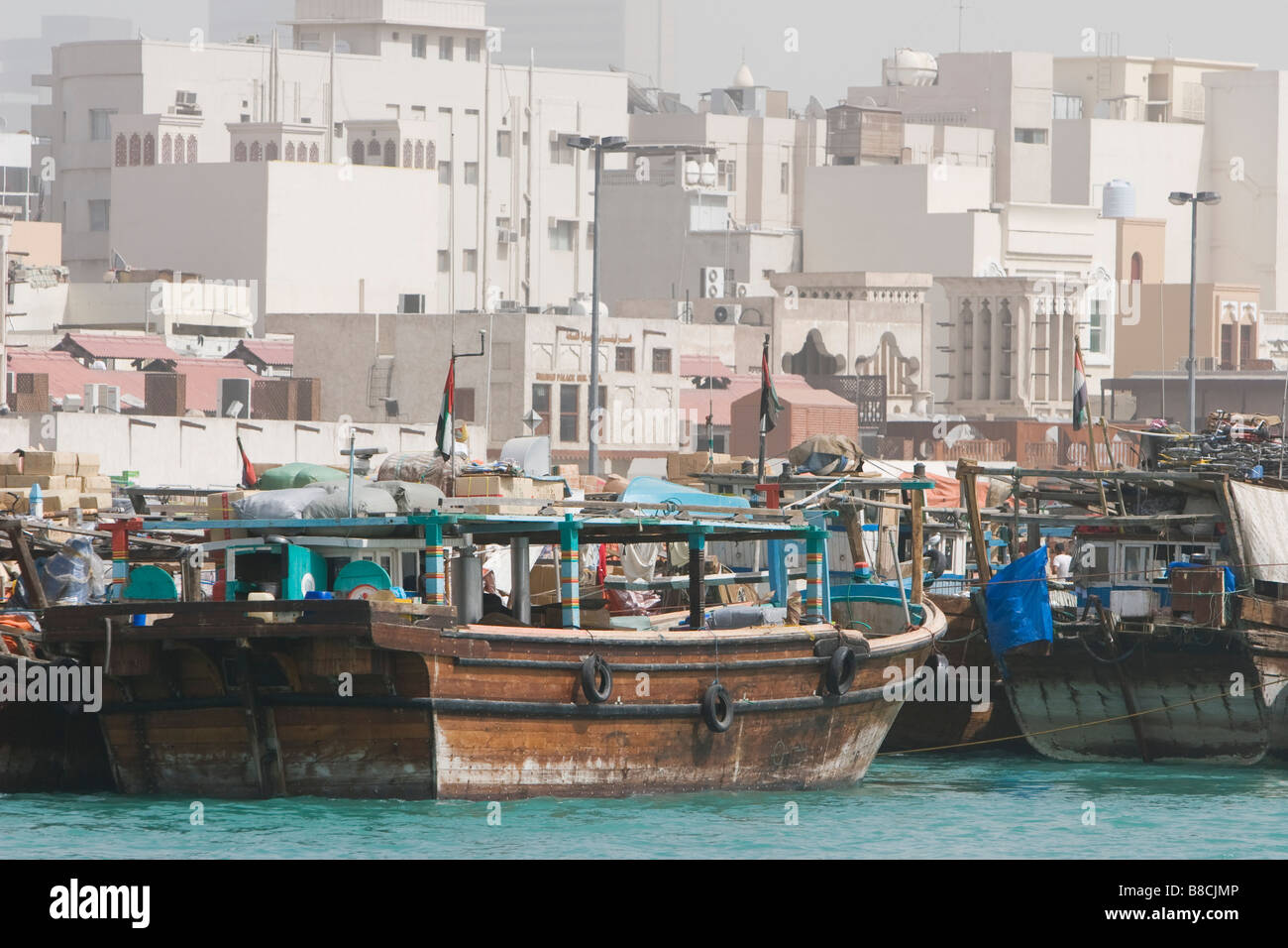 Dubai, UAE, Dhows, old wooden sailing vessels, are docked along the Deira side of Dubai Creek. Stock Photo