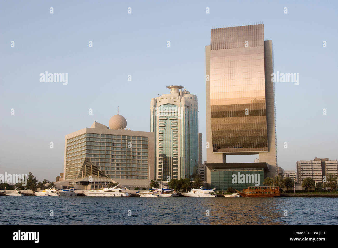 Dubai, UAE, Beautiful waterfront view of Deira’s skyline at sunset on Dubai Creek, the shiny bronze. Stock Photo