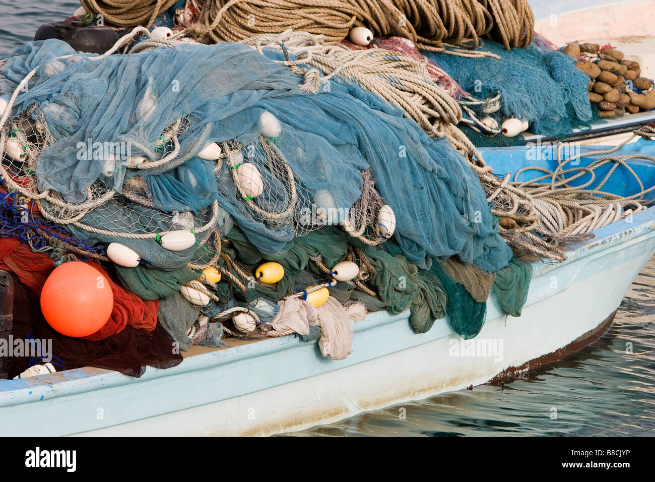 Kalba, UAE, Fishing nets piled high on boat in Kalbar Fujairah Stock