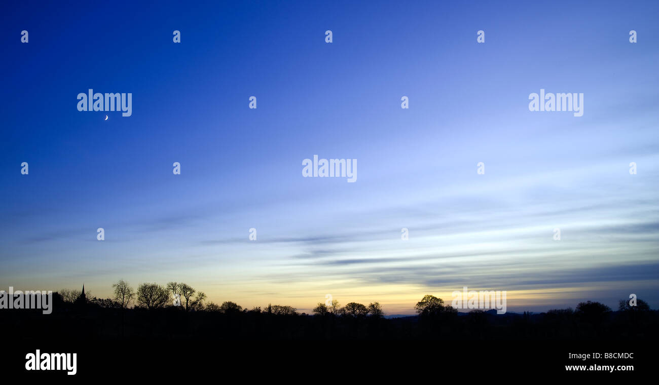 A twilight shot of the clear winter sky over the English countryside as night falls. Stock Photo
