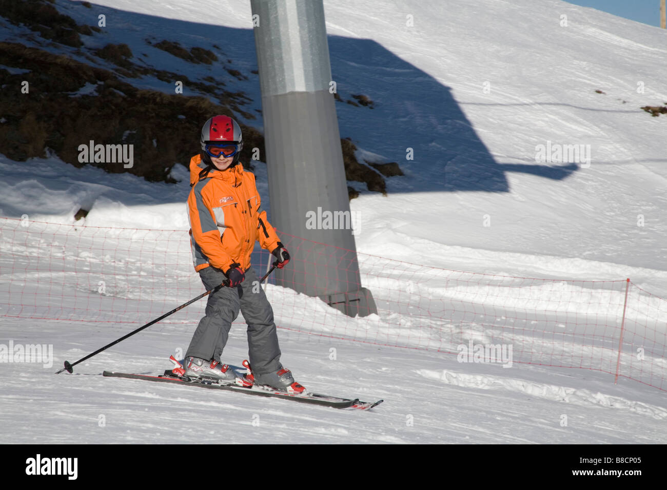Rauris Austria EU January Young girl descending the upper ski slopes Stock Photo