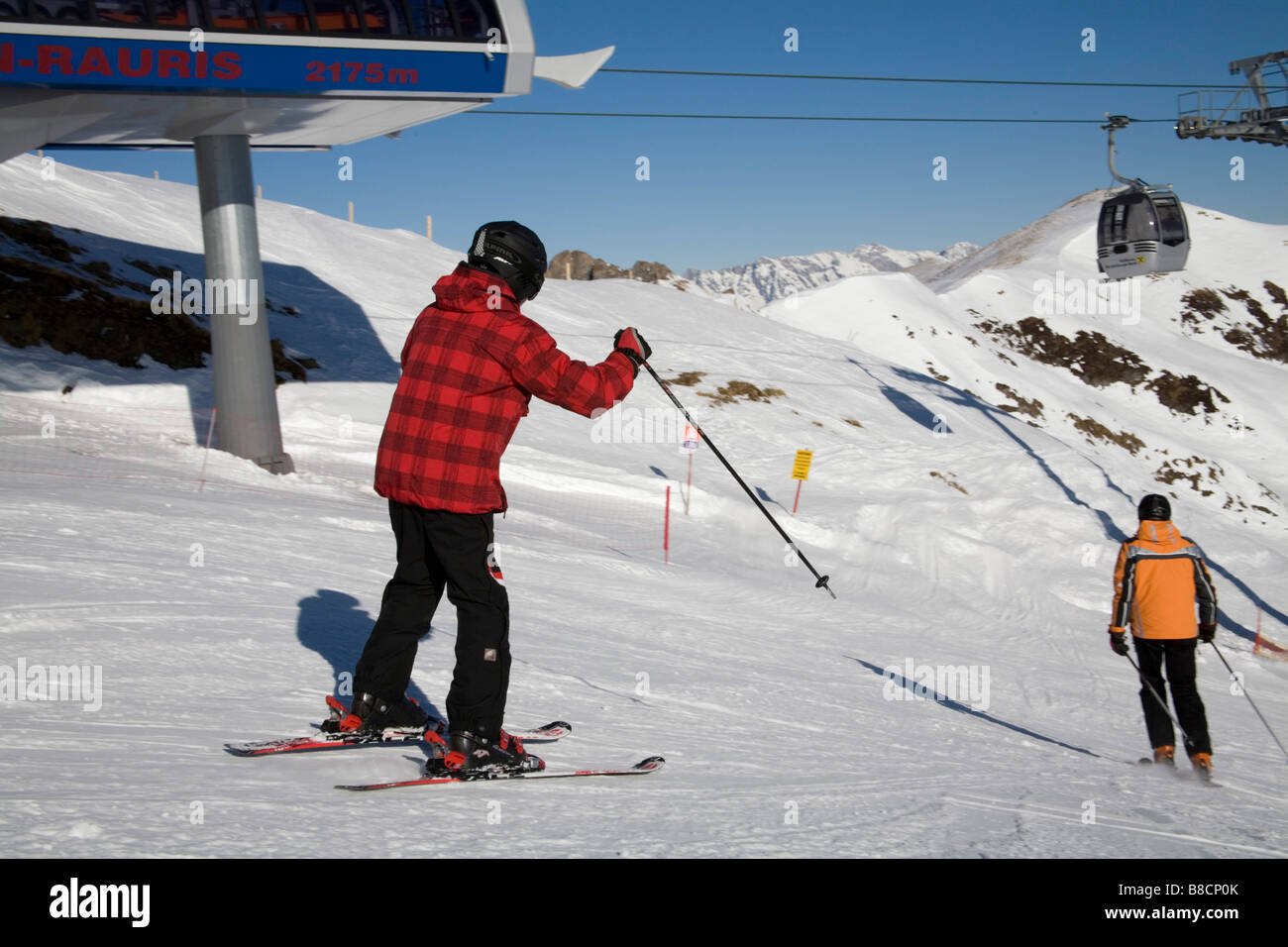 Rauris Austria EU January Two skiers descending the upper ski slopes from the Hochalmbahn gondola station Stock Photo