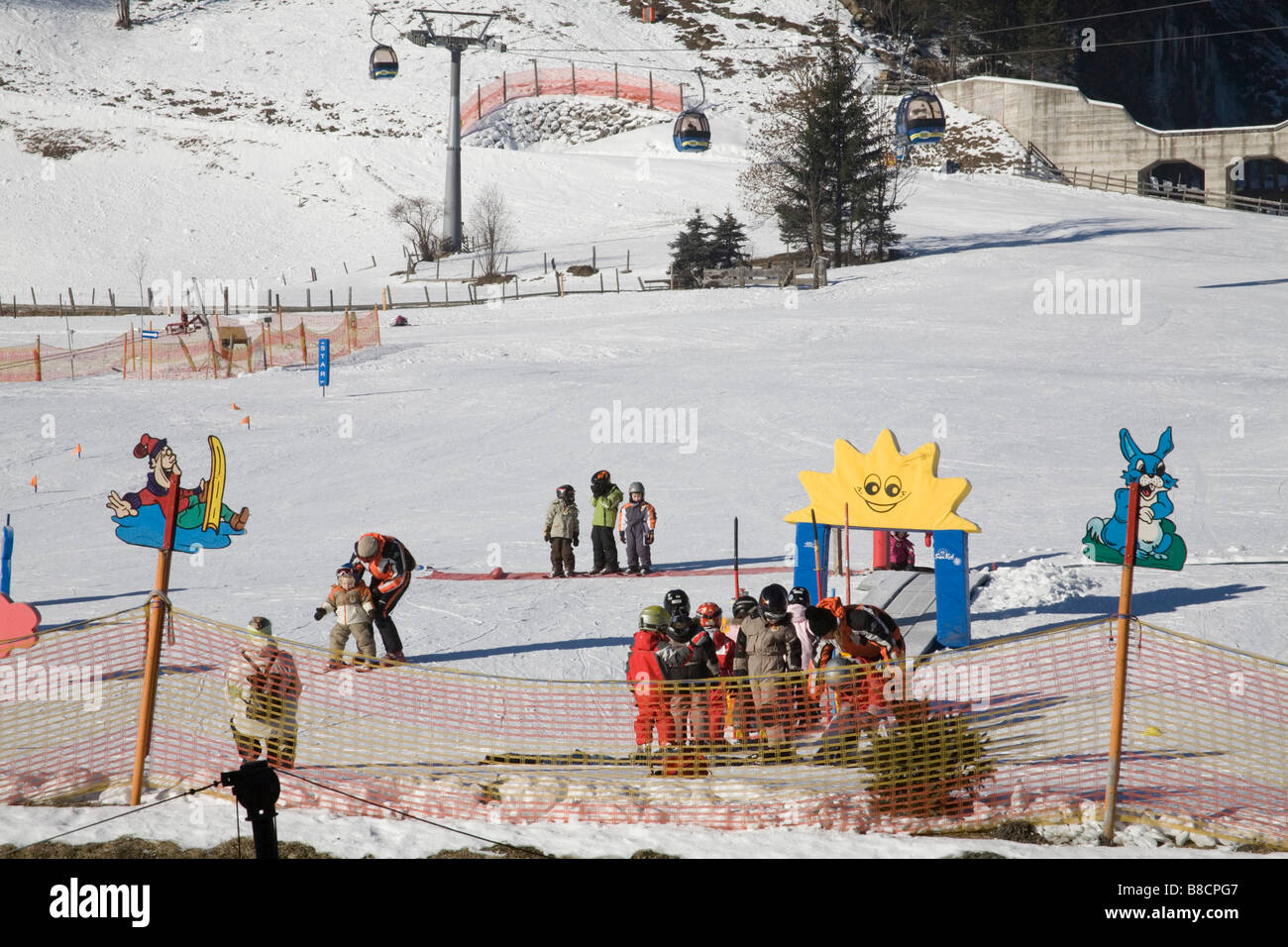 Rauris Austria EU January Group of young children having basic skiing lessons on the nursery slopes Stock Photo