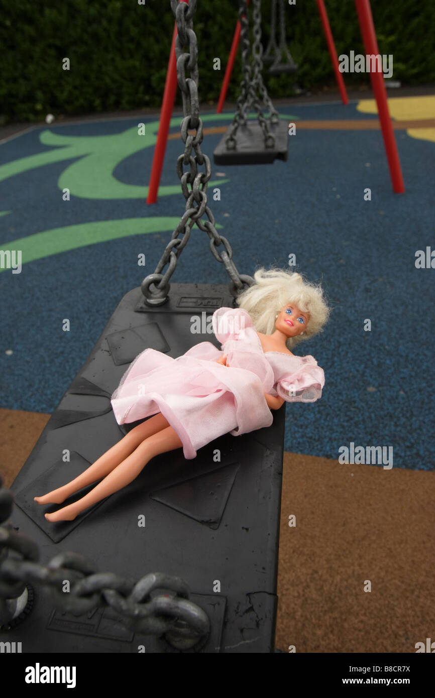 A Barbie doll on a swing in a play park Stock Photo Alamy