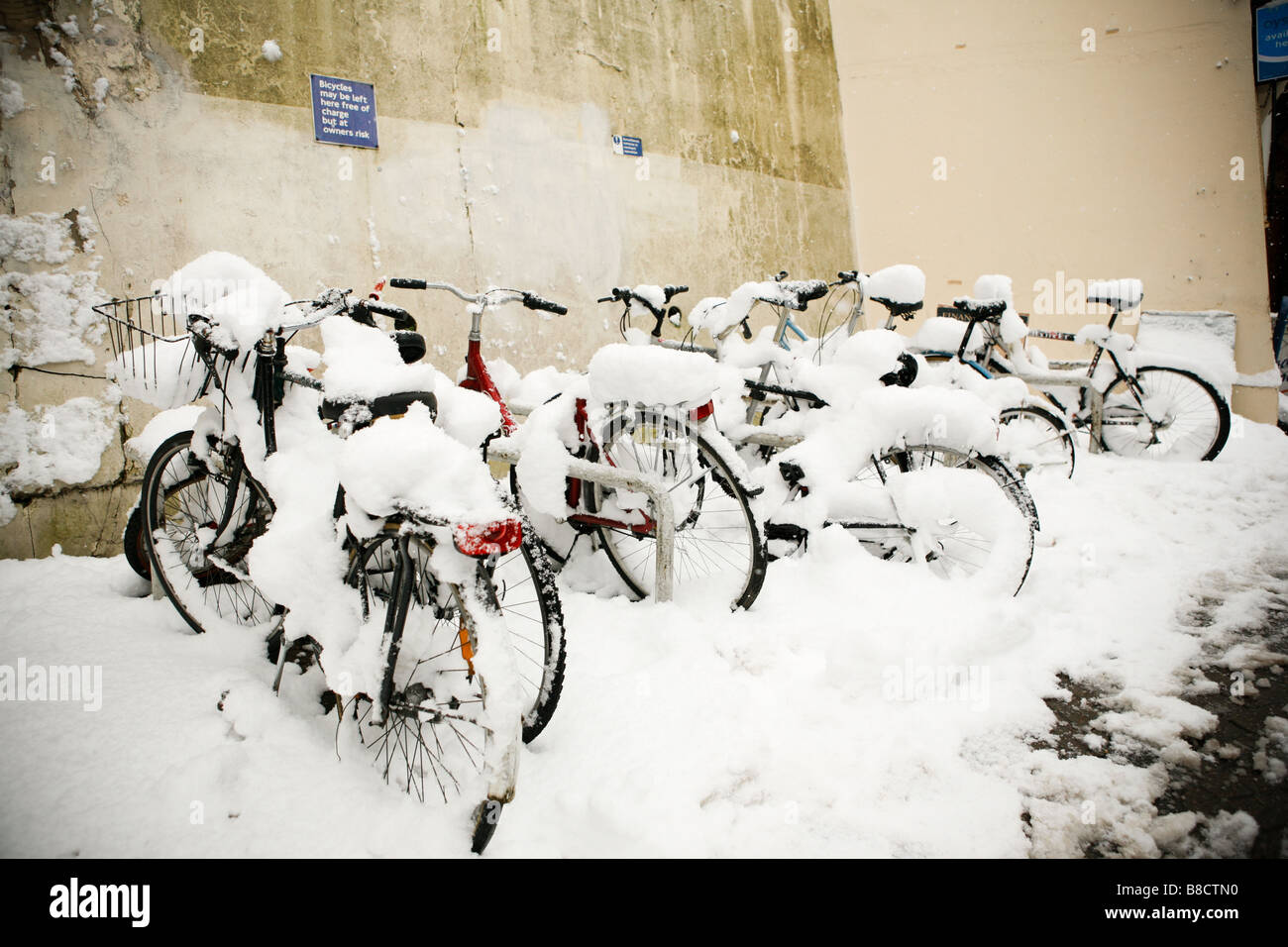 Snow covered bicycles lined up in winter Stock Photo Alamy