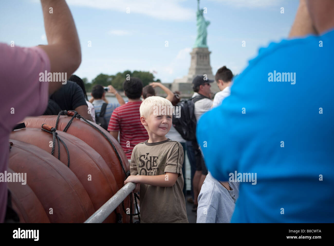 portrait of a child in a crowd near the statue of liberty Stock Photo