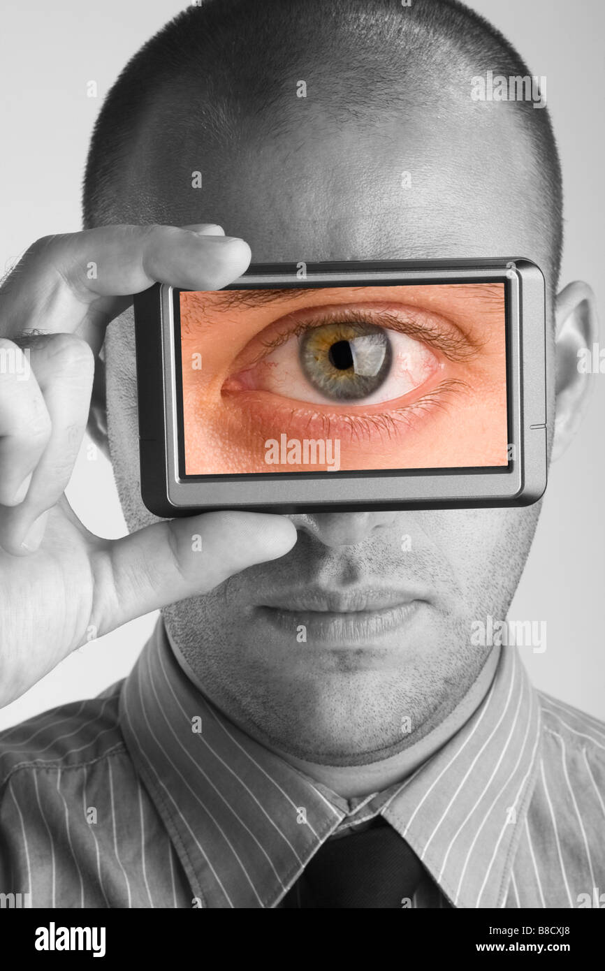 Businessman holding visual screen monitor showing picture of an eye Stock Photo