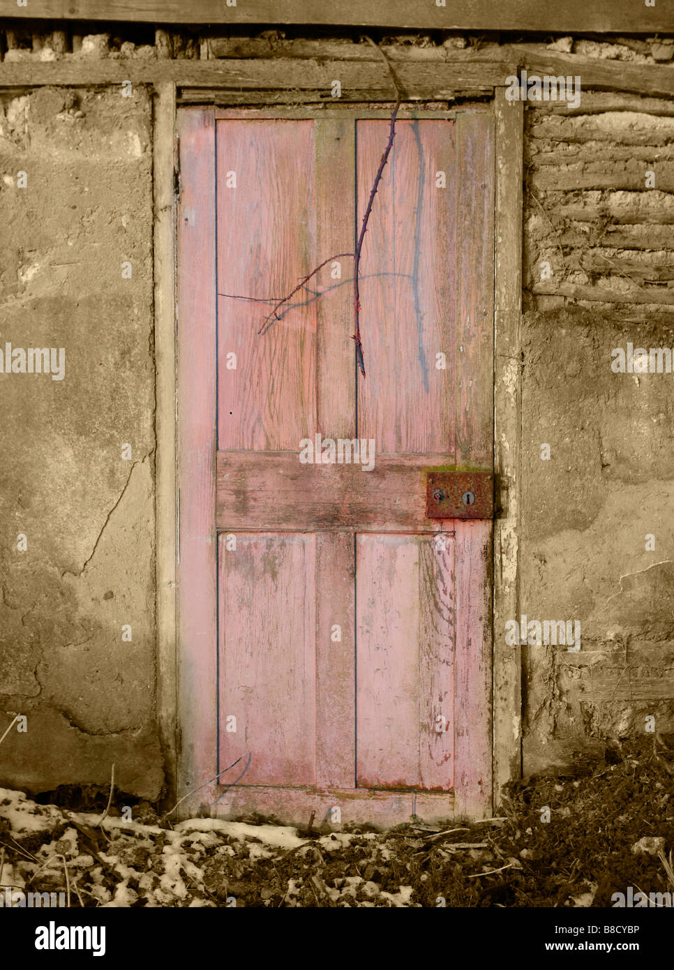 An old door in a very old building! The paint had degraded into a lush pink. Stock Photo
