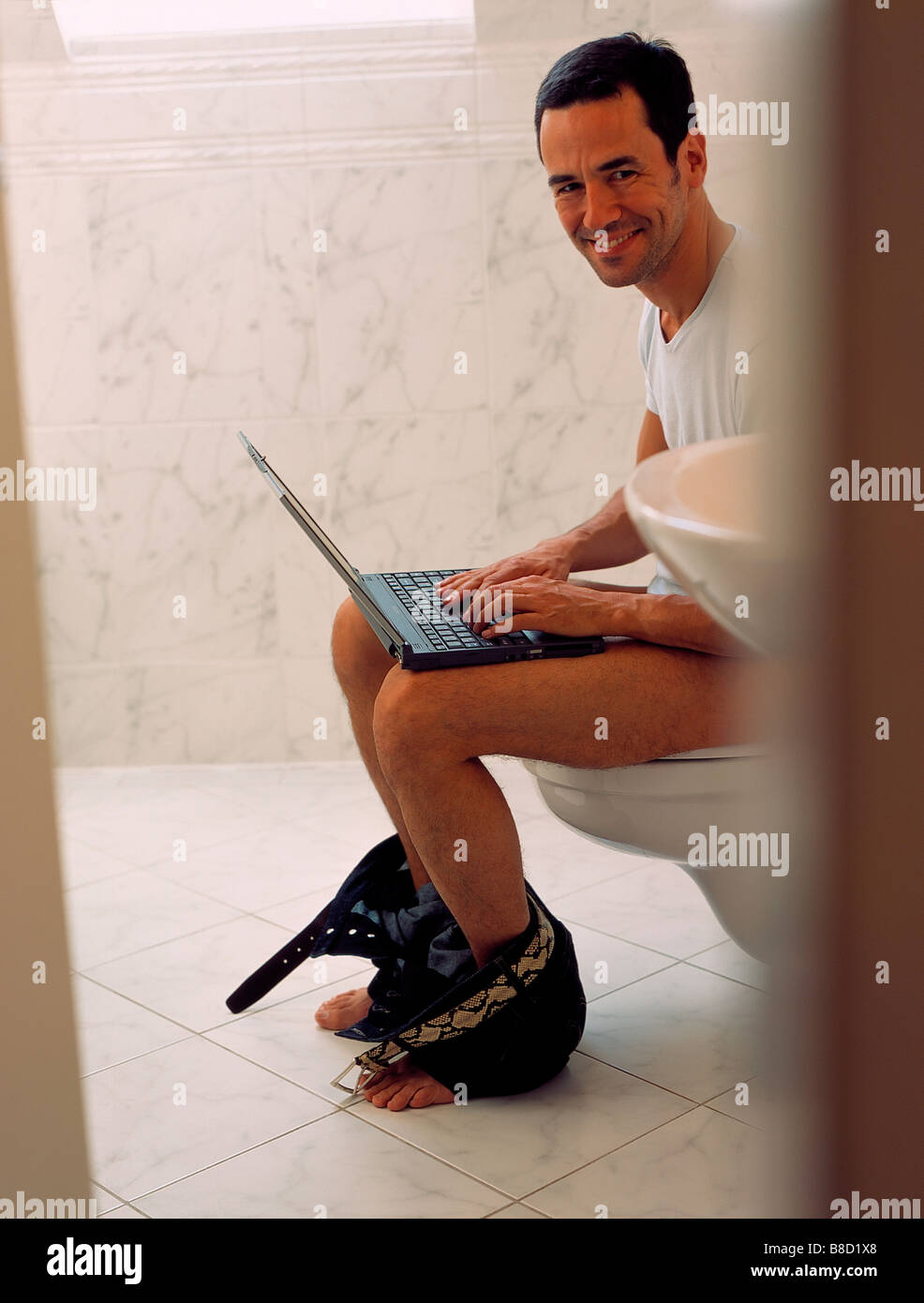FV3011, Malek Chamoun; Man Bathroom using Laptop Stock Photo