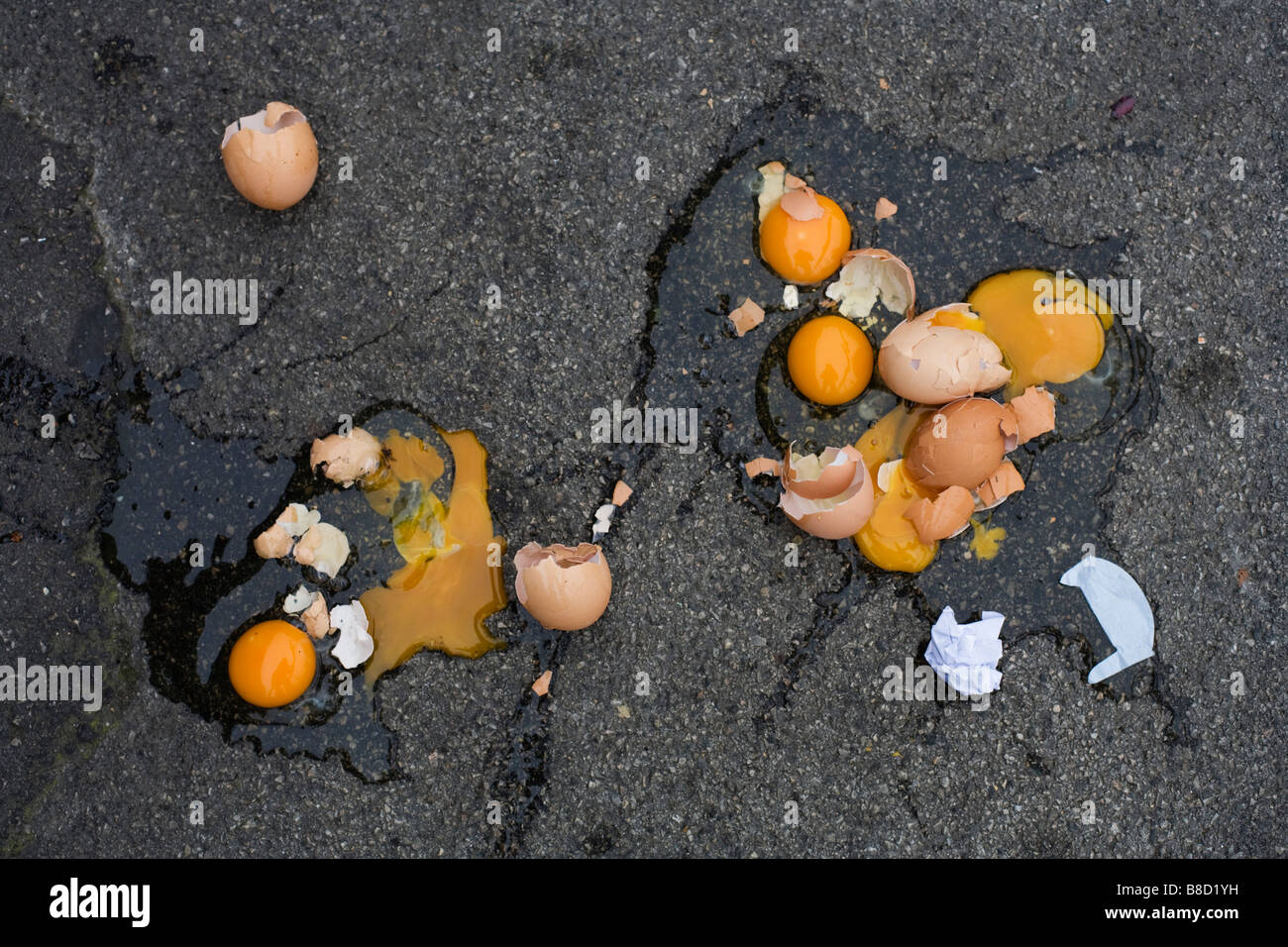 Broken eggs dropped on tarmac Stock Photo