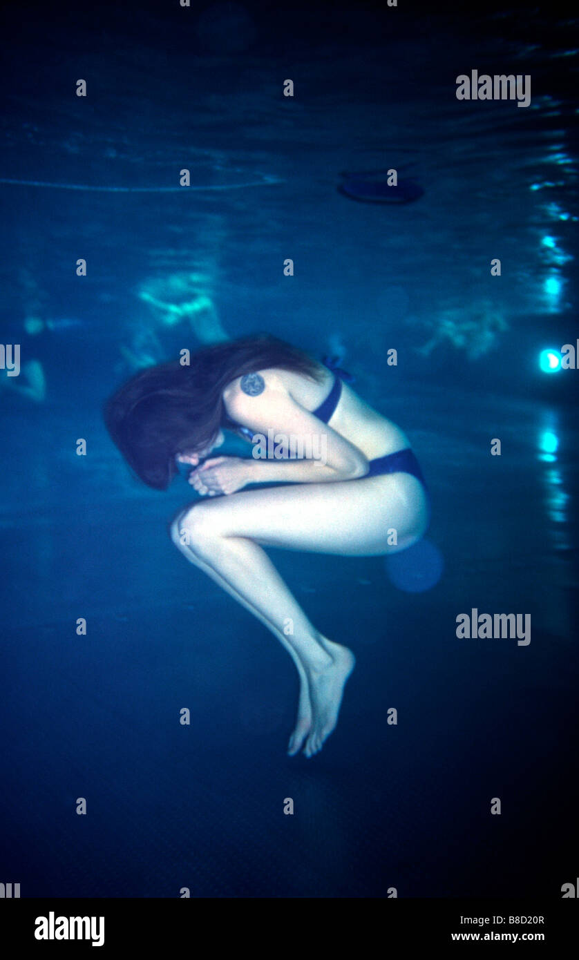 FV3024, Malek Chamoun; Woman Underwater Fetal Position Stock Photo