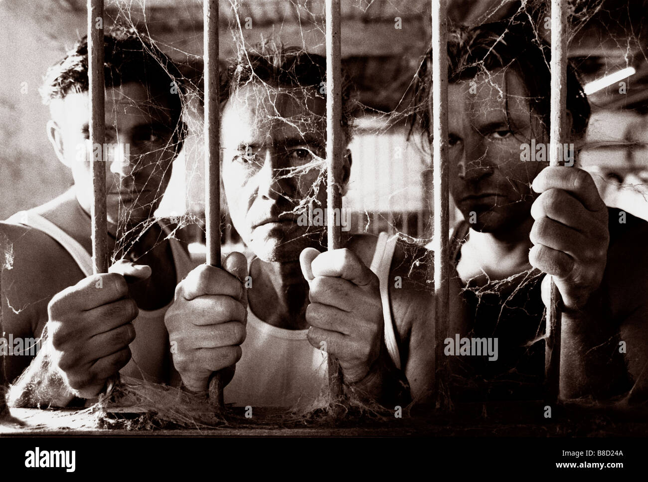 FV3044, Malek Chamoun; BW 3 Men Behind Bars Stock Photo