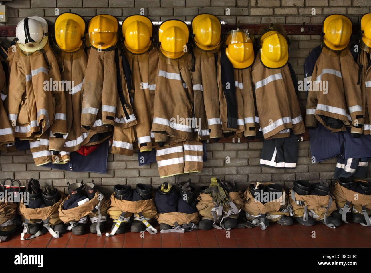 Fireman uniforms hanging up Stock Photo Alamy