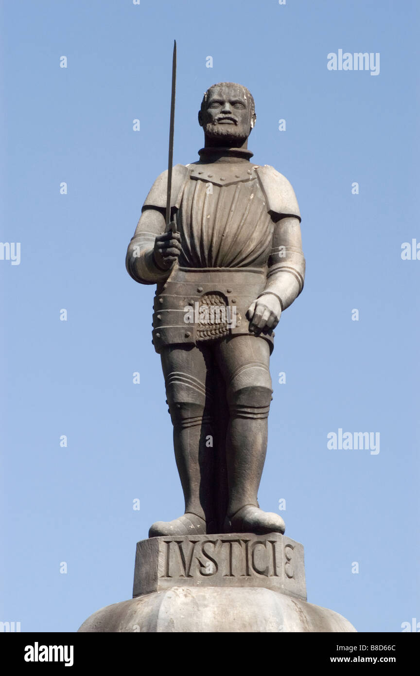 Man with sword statue on whipping post, pillory, Old Market Square, Poznan, Poland Stock Photo