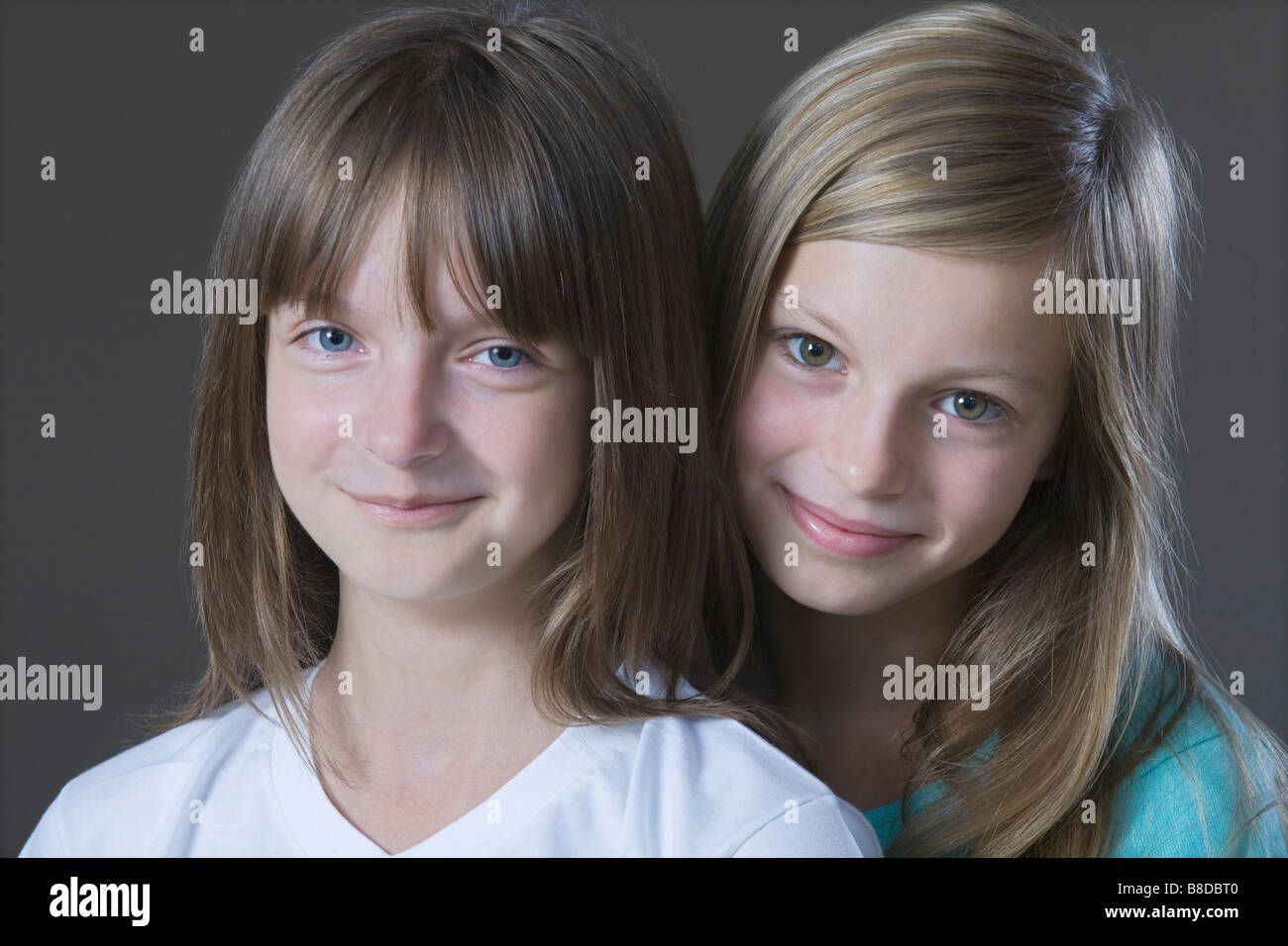Studio portrait of two girl smiling Stock Photo - Alamy